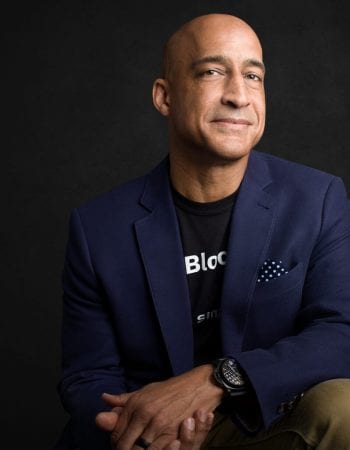 Jason Kelley, Chairman of the Board, sitting on a black background.