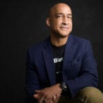 Jason Kelley, Chairman of the Board, sitting on a black background.