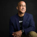 Jason Kelley, Chairman of the Board, sitting on a black background.
